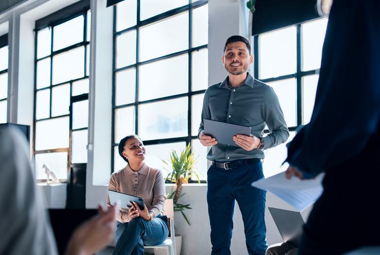 Schulungen & Trainings Menschen in einem Büro mit Tablets in den Armen